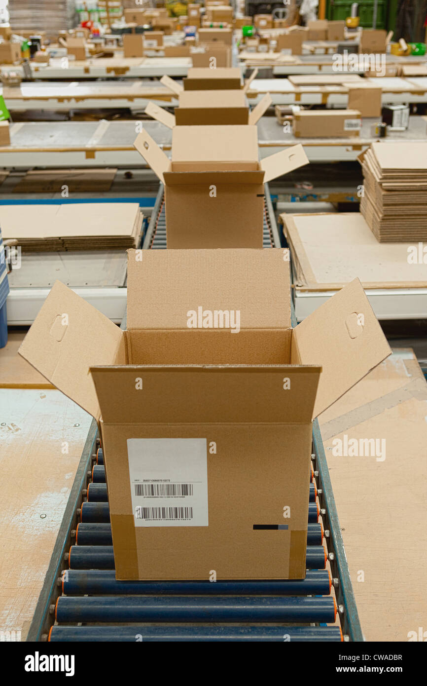 Open cardboard boxes on conveyor belt Stock Photo Alamy