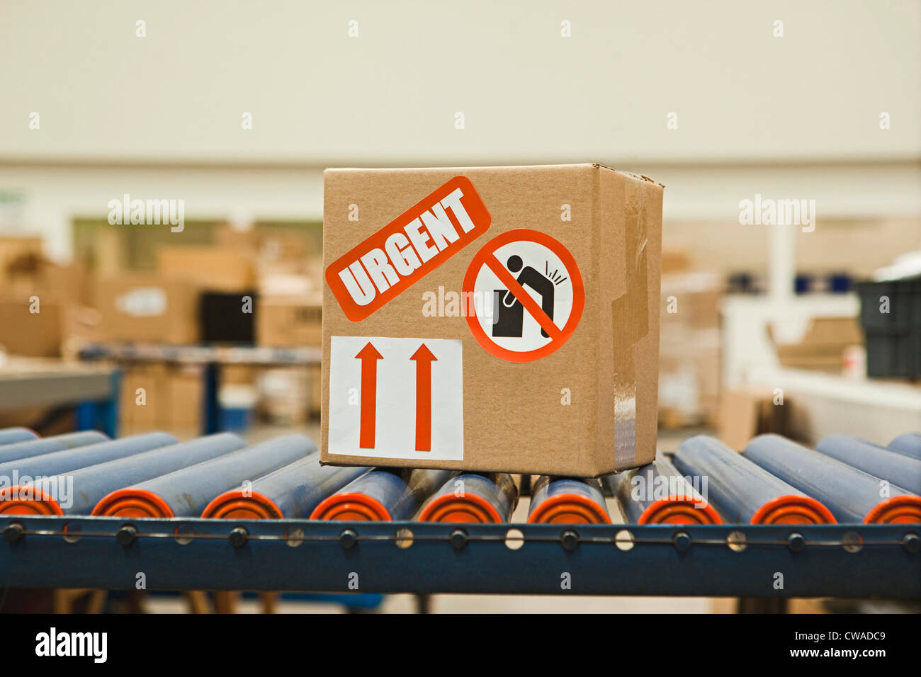 Cardboard box with warning stickers on conveyor belt Stock Photo Alamy
