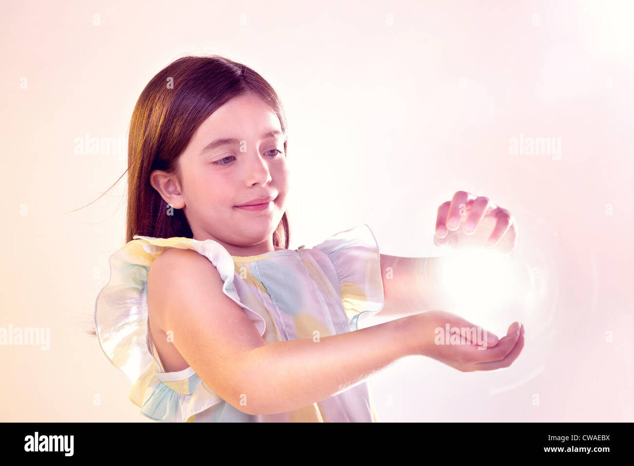 Girl holding a ball of light Stock Photo Alamy