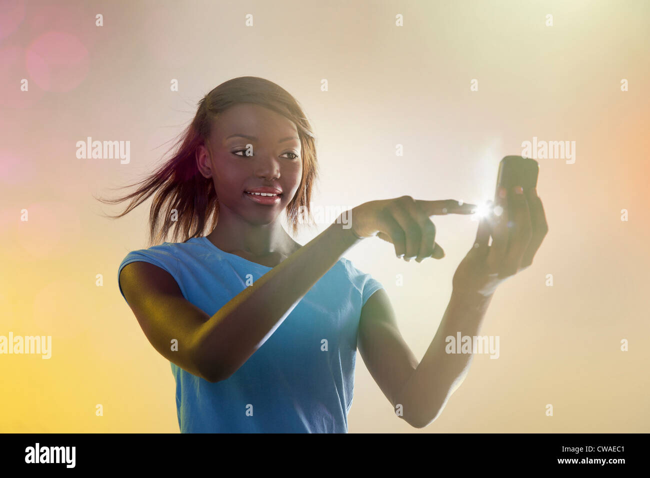Teenage girl using illuminated cellphone Stock Photo