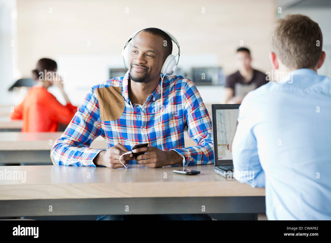 Young man in break room listening to music Stock Photo