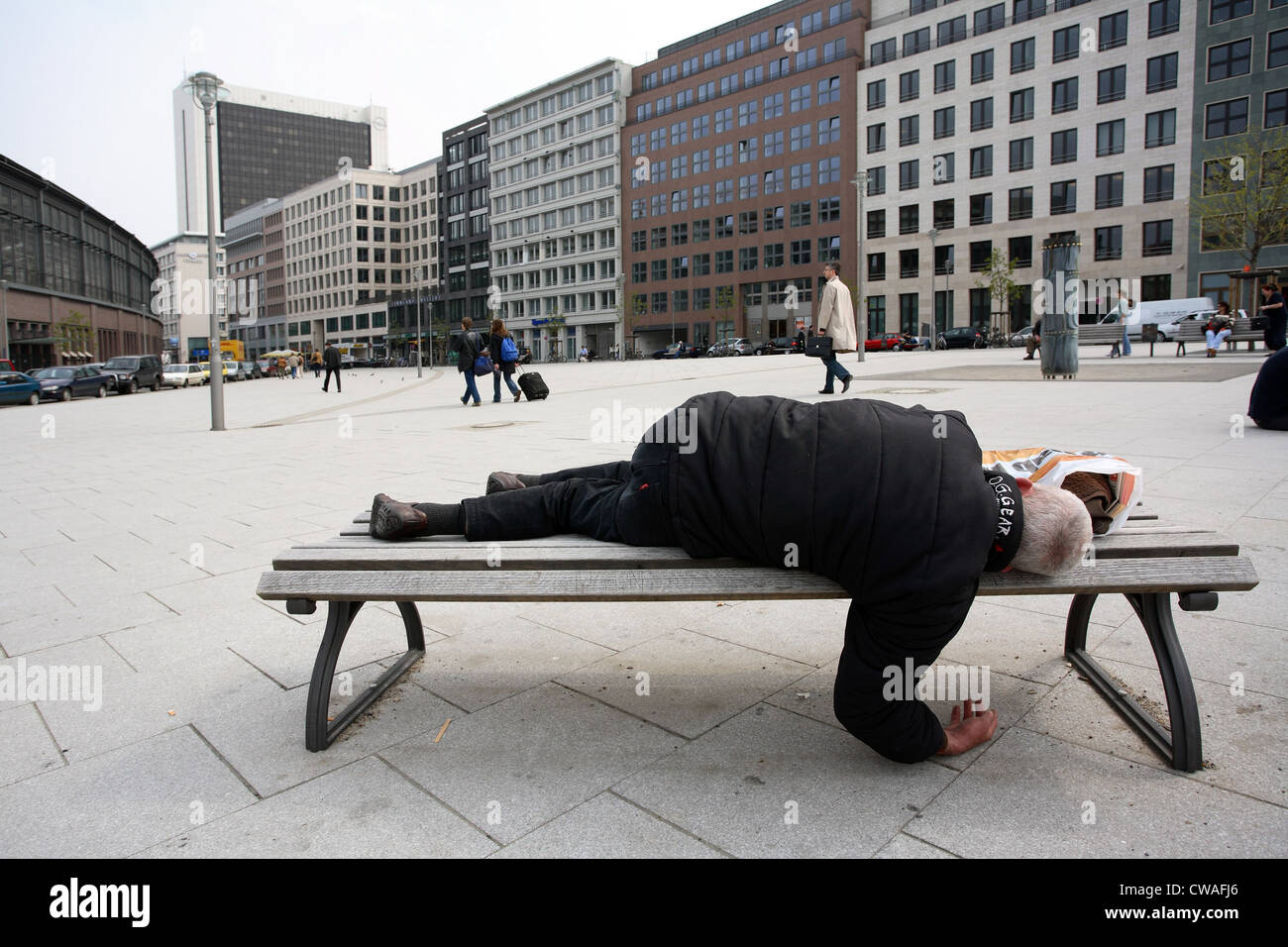 Homeless person is sleeping on a bench in Berlin Stock Photo - Alamy