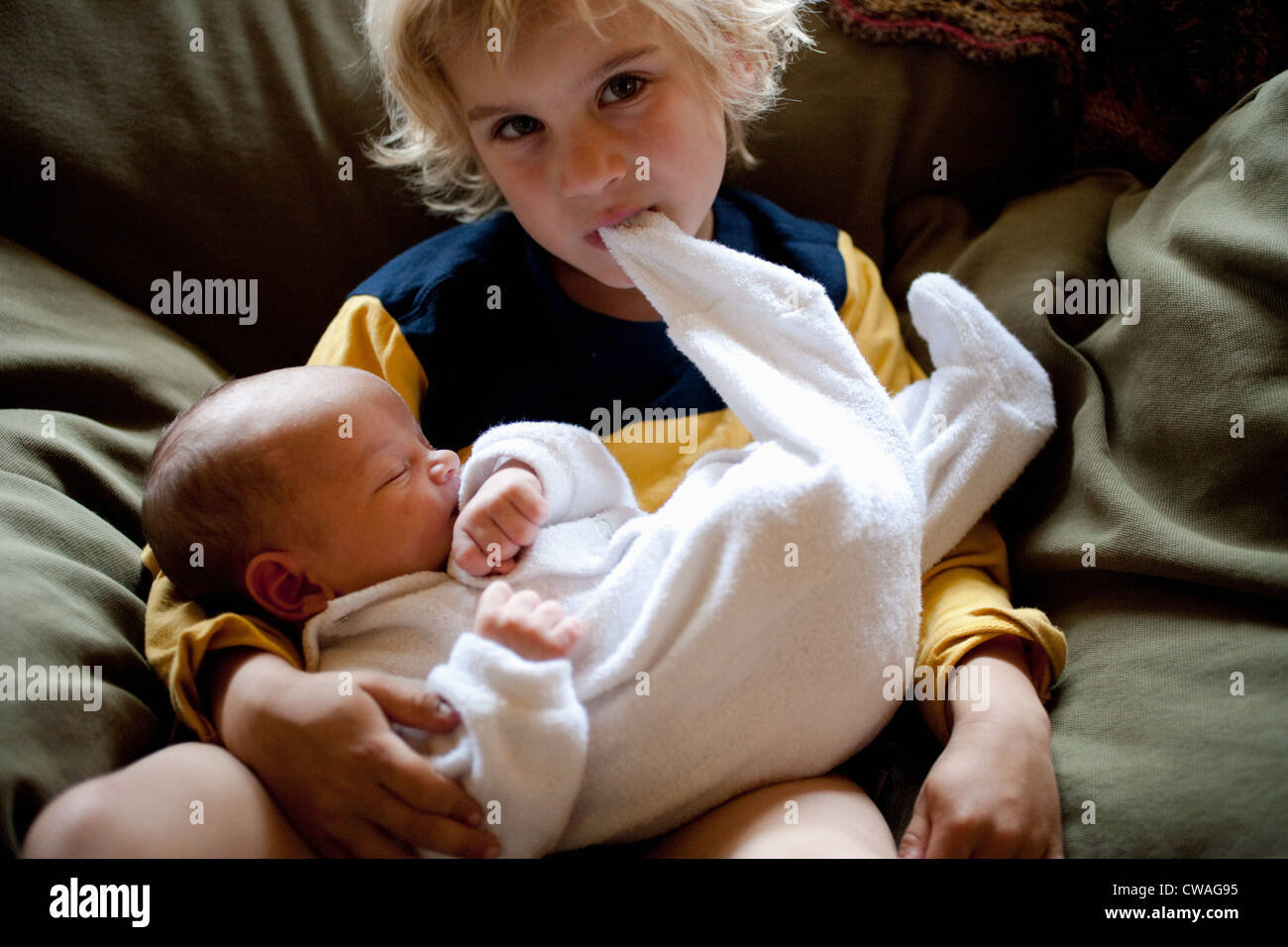 Young boy holding baby brother Stock Photo Alamy