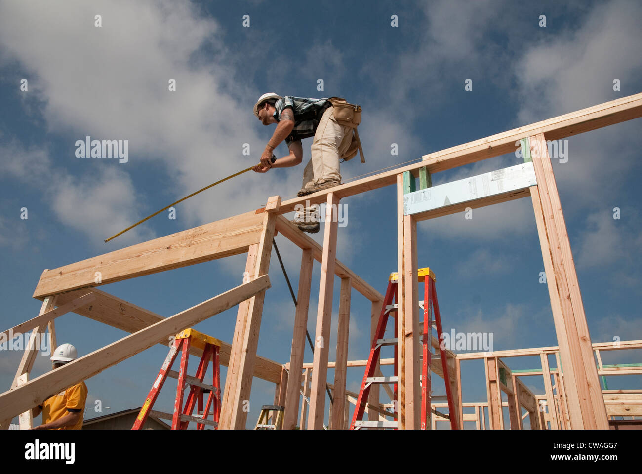 Company employees volunteer their time, help build an affordable house