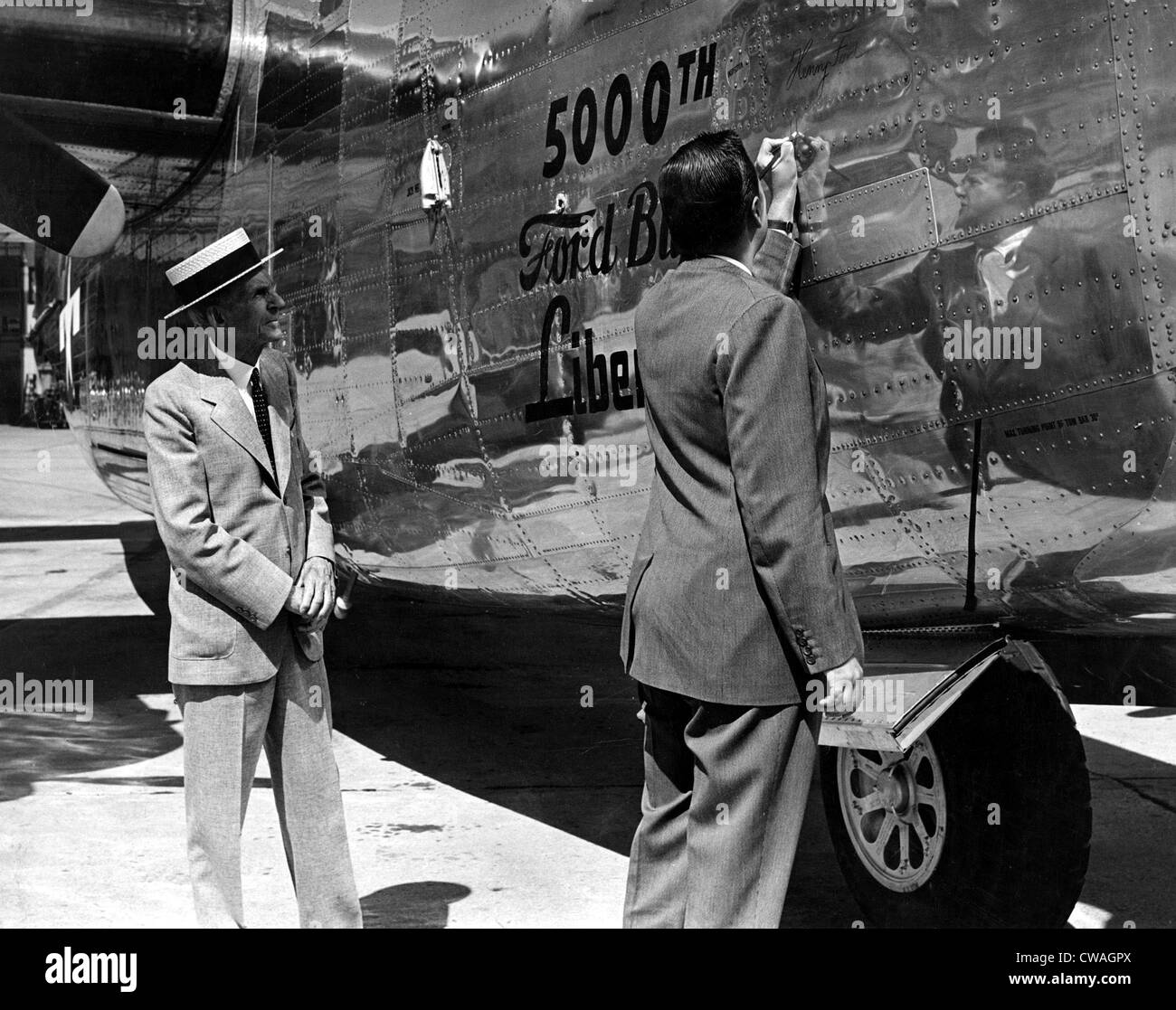 Henry Ford & grandson Henry Ford II, sign 5,000th Liberator bomber built, 9/9/44. Courtesy: CSU Archives / Everett Collection Stock Photo