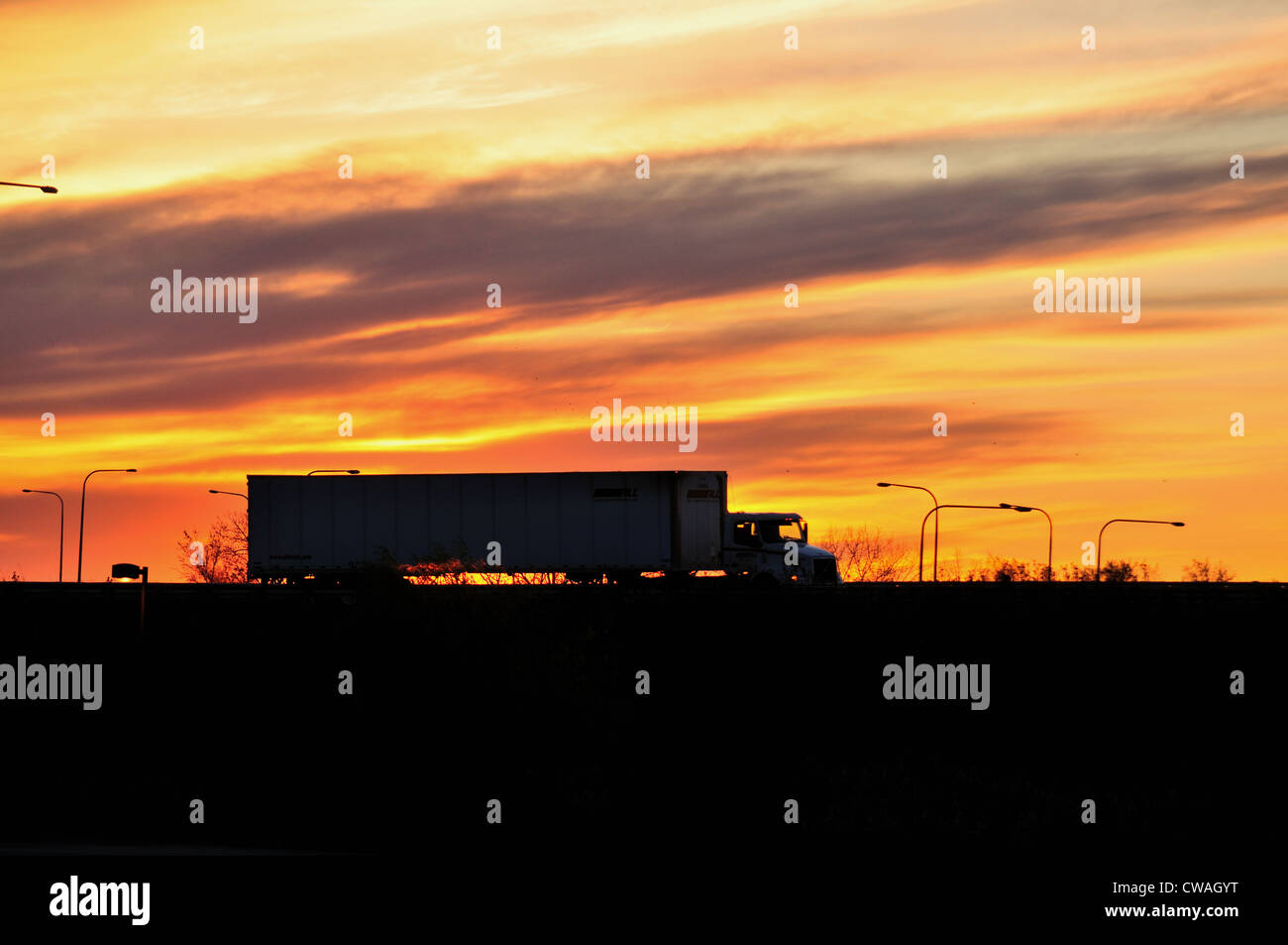 Container truck highway sunset silhouette Stock Photo