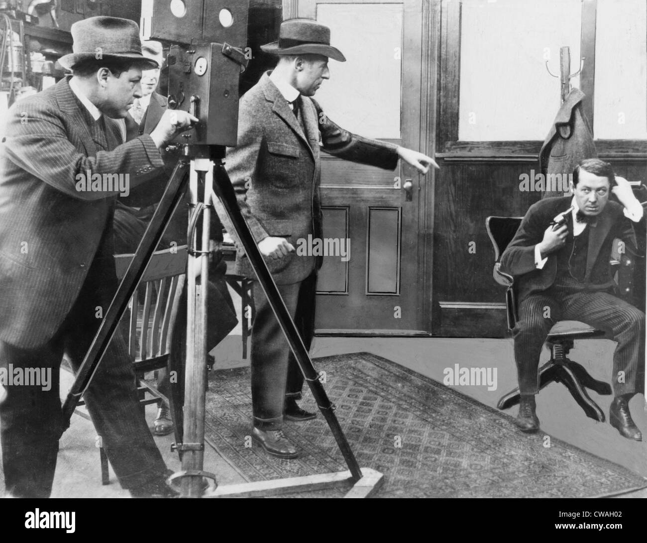 D.W. Griffith (1875-1948) directing Henry B. Walthall in 1914 film THE AVENGING CONSCIENCE with Billy Bitzer at the camera. Stock Photo
