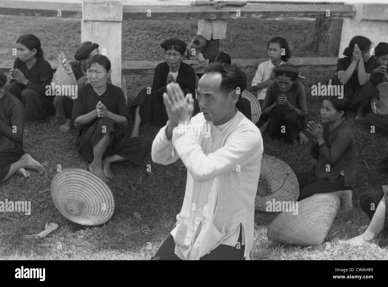 Vietnamese refugees from the First Indo-Chinese War (1946-1954) in Thailand in 1955.  Photo title is 'Prayer for Refuge' Stock Photo