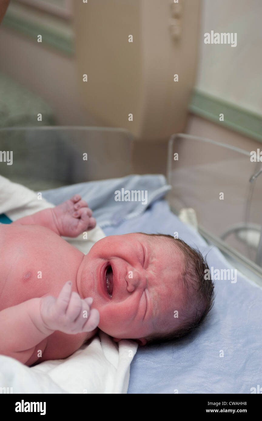 Newborn baby girl crying Stock Photo