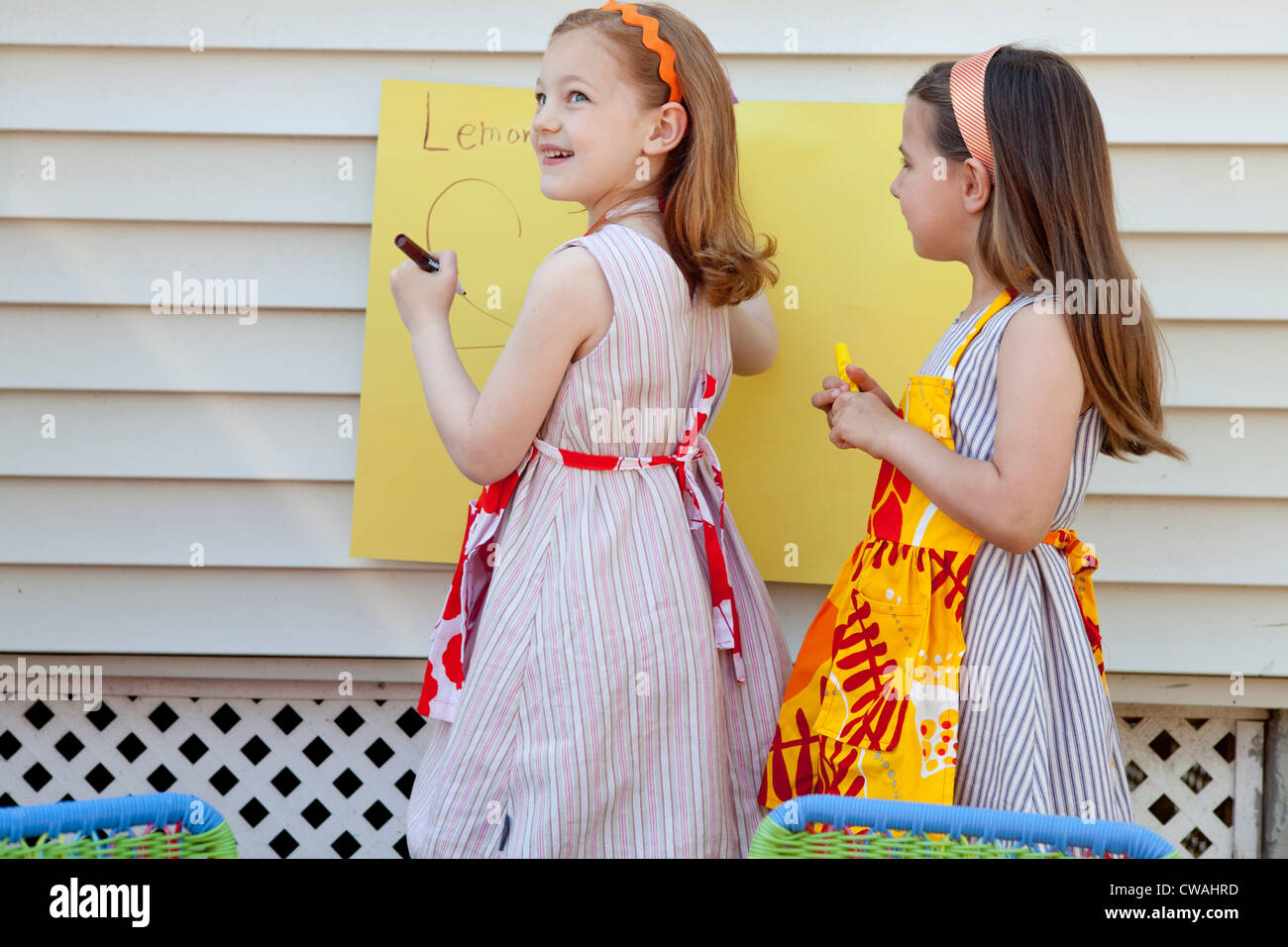 Girls making sign for selling homemade lemonade Stock Photo