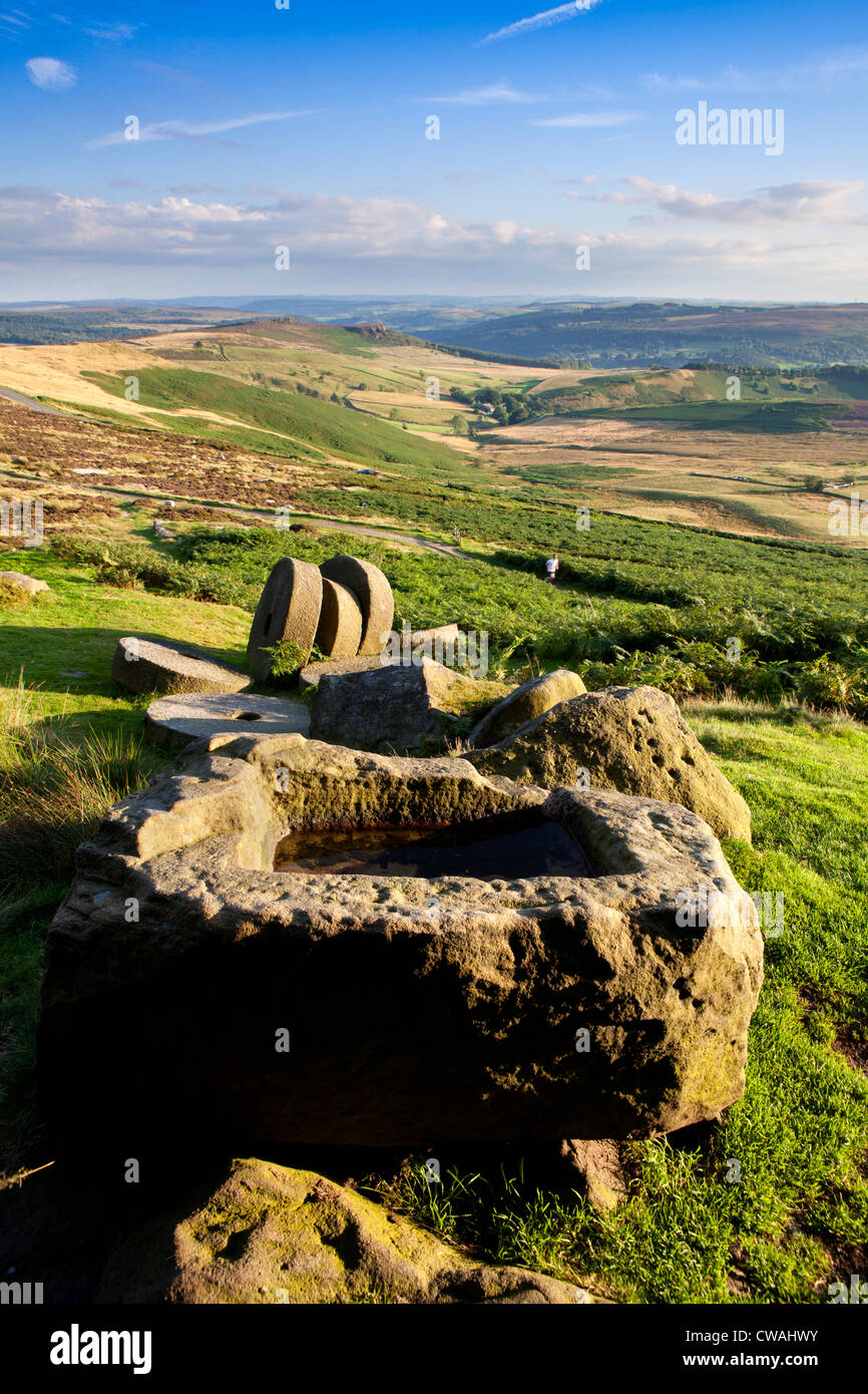 Abandoned trough and millstones below Stanage Edge, Peak District, Derbyshire, England, UK Stock Photo