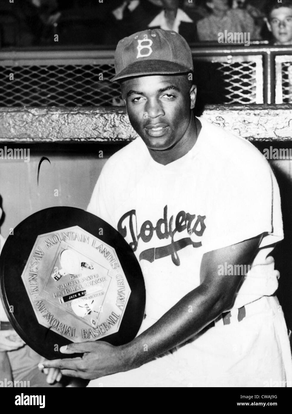 Baseball player Jackie Robinson of the Brooklyn Dodgers holds his MVP award in 1949.Courtesy CSU Archives/Everett Collection. Stock Photo