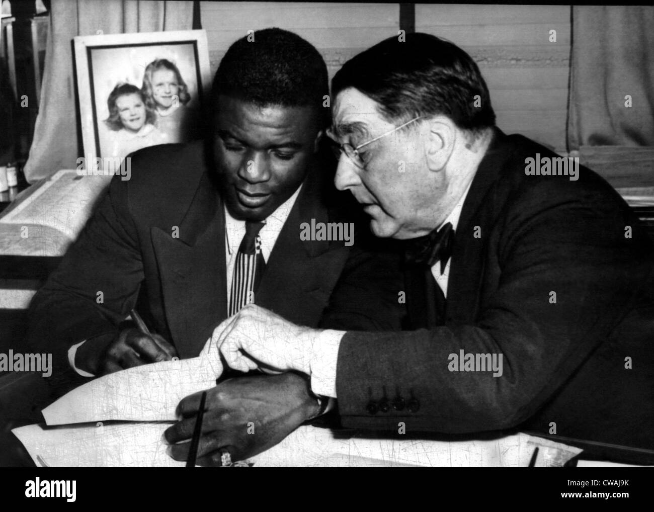 Jackie Robinson (left), being signed by Branch Rickey (right), to a one year contract to play for the Brooklyn Dodgers, 1945.. Stock Photo
