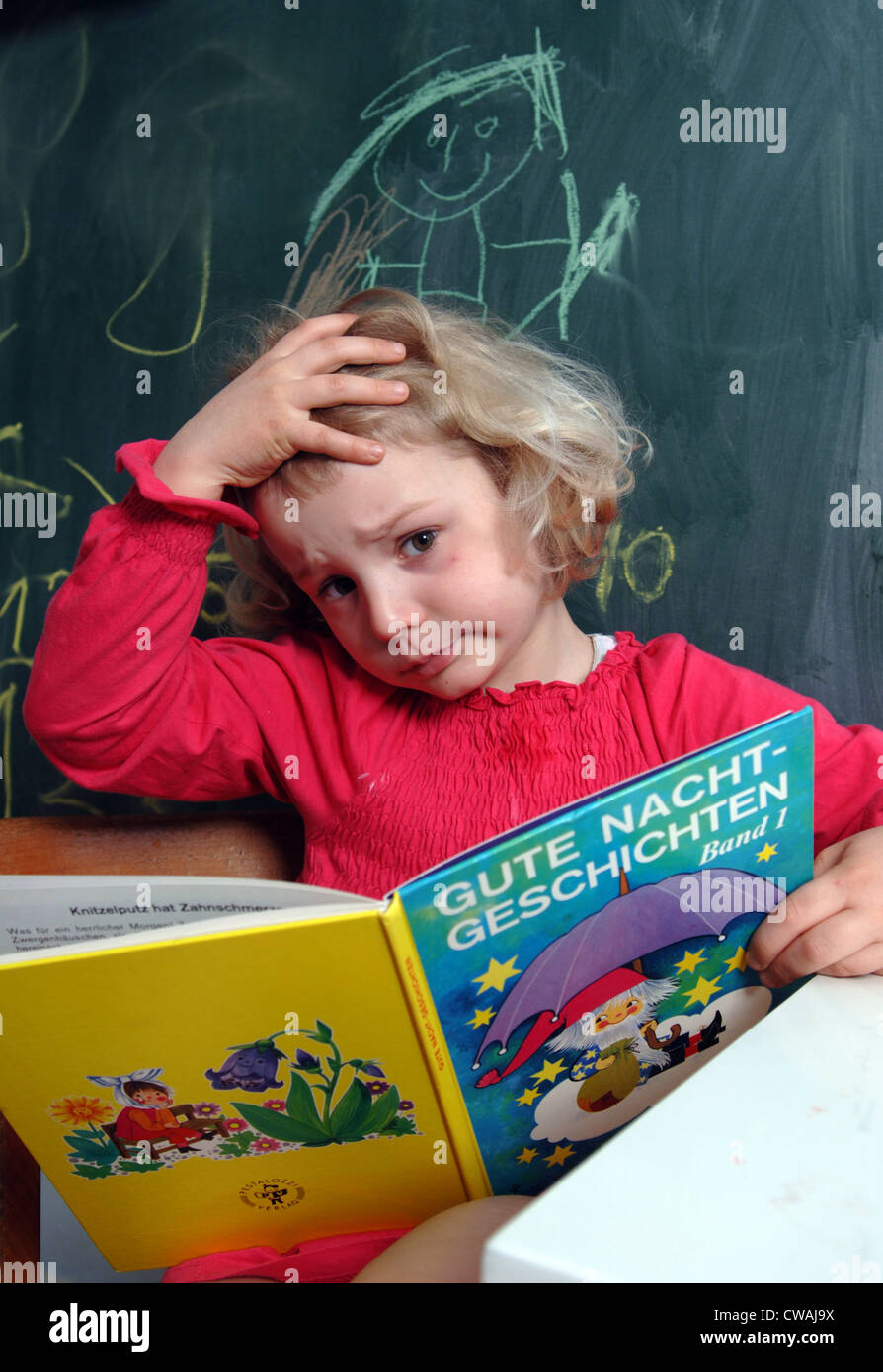 Girl reading a book, Berlin Stock Photo - Alamy
