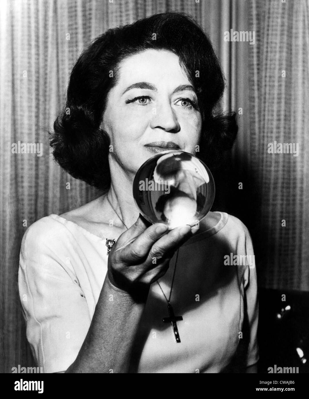 Astrologer and psychic Jeane Dixon holding a crystal ball. Courtesy: CSU Archives/Everett Collection. Stock Photo