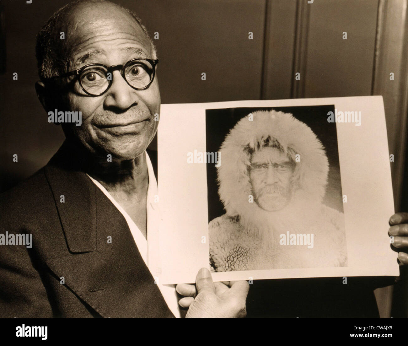 Matthew Henson (1866-1955), African American Arctic explorer, holding a portrait Admiral Robert E. Peary, his expedition Stock Photo