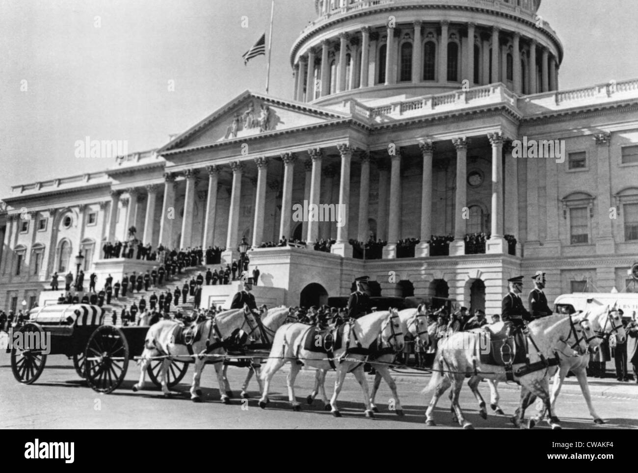 Horse-drawn carriages bearing remains of President John F. Kennedy after his assassination, pulling away from the Capitol to Stock Photo