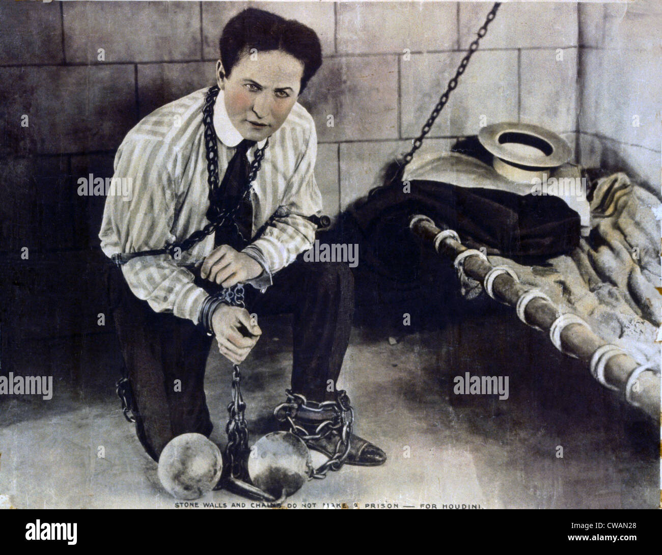 Harry Houdini (1874-1926), in still from a movie he made with Famous Players-Lasky Corporation, shows him chained in a prison Stock Photo