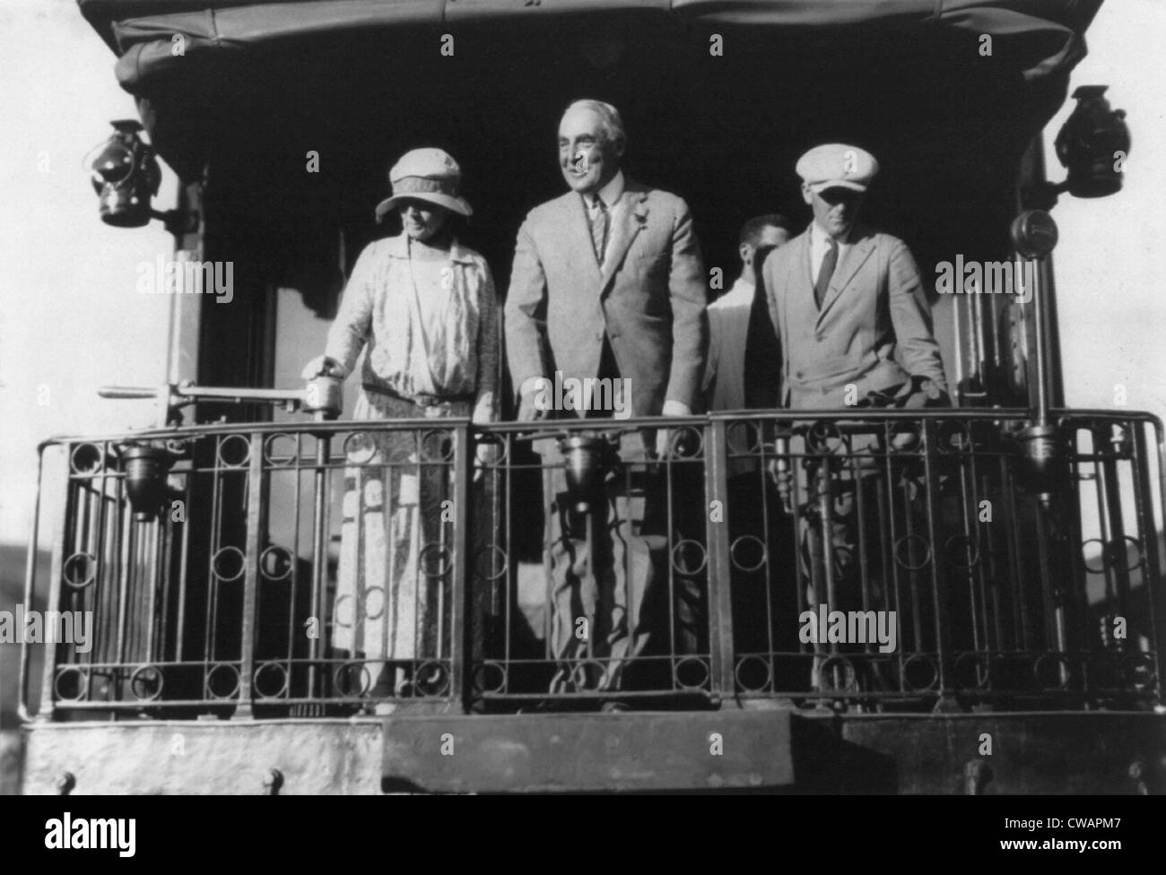 Warren G. Harding (1865-1923), standing on back of Northern Pacific train, with wife Florence and others as they leave Stock Photo