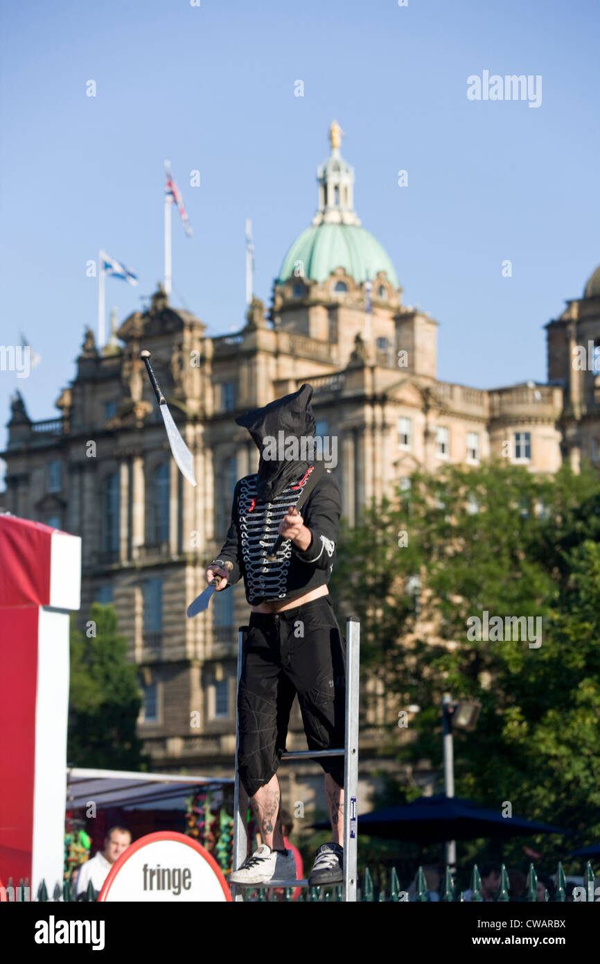 A Edinburgh fringe street busker juggling in front of the Bank of Scotland. Stock Photo