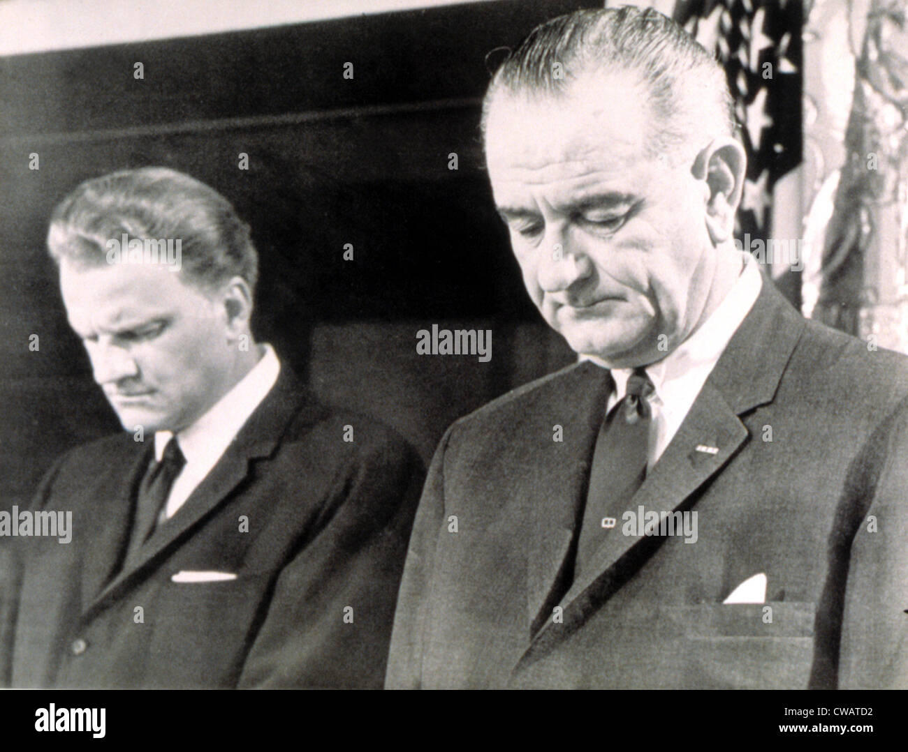 Billy Graham & President Lyndon B. Johnson in prayer at the White House, 1964. Courtesy: CSU Archives / Everett Collection Stock Photo