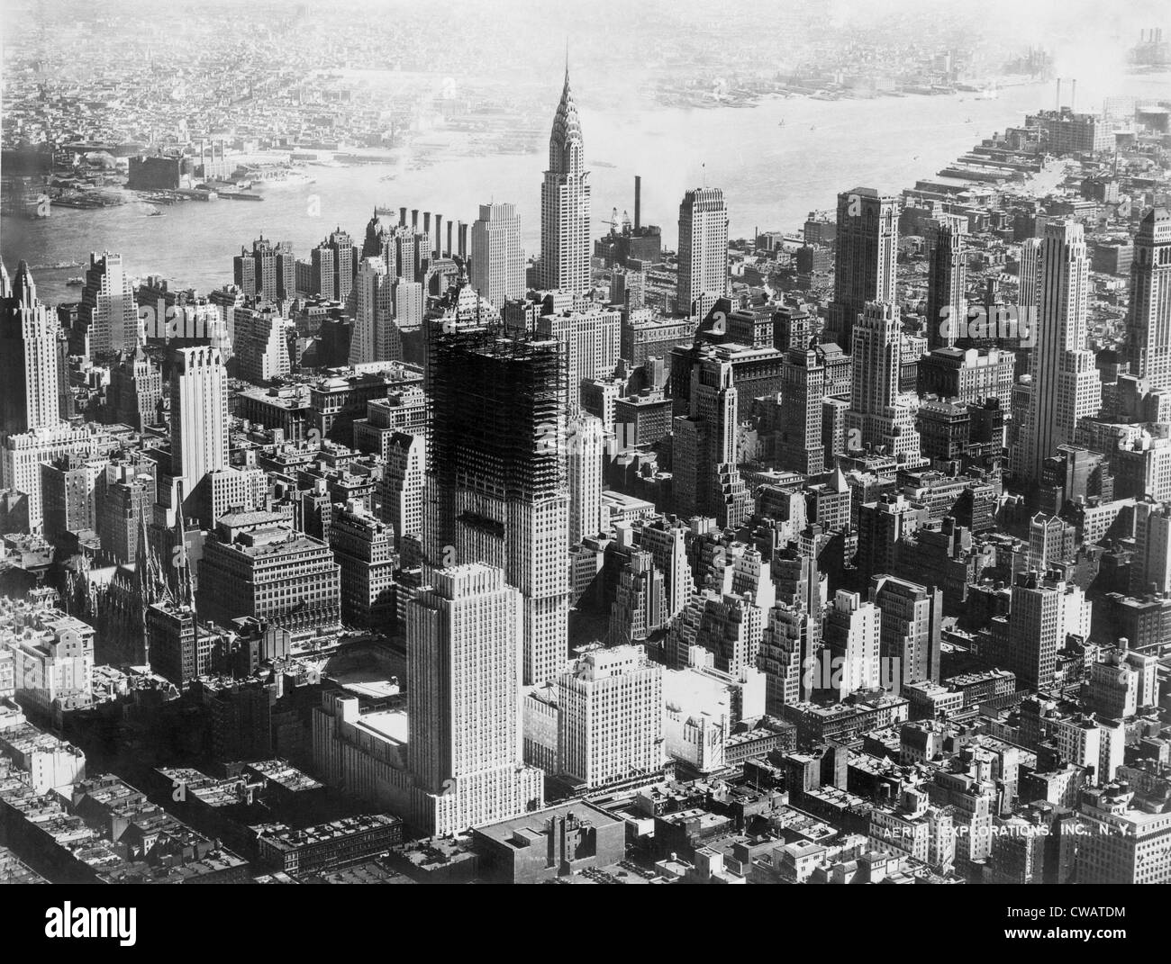 Aerial view of mid-town Manhattan during construction of Rockefeller Center.  In center background is the Chrysler building. Stock Photo