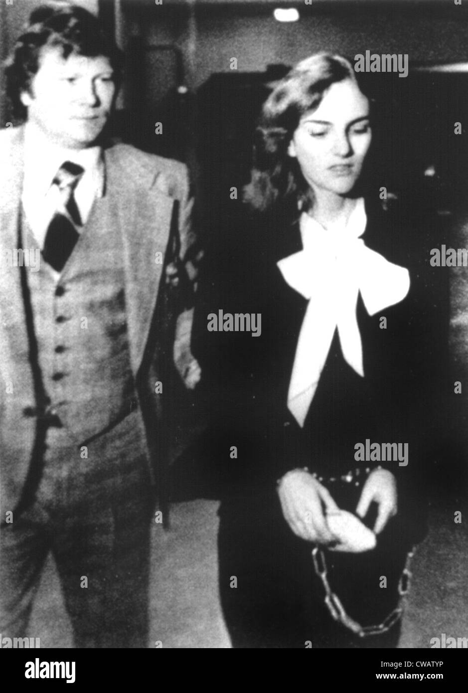 Patricia Hearst being escorted during her trial in San Francisco, CA, 1976.. Courtesy: CSU Archives / Everett Collection Stock Photo
