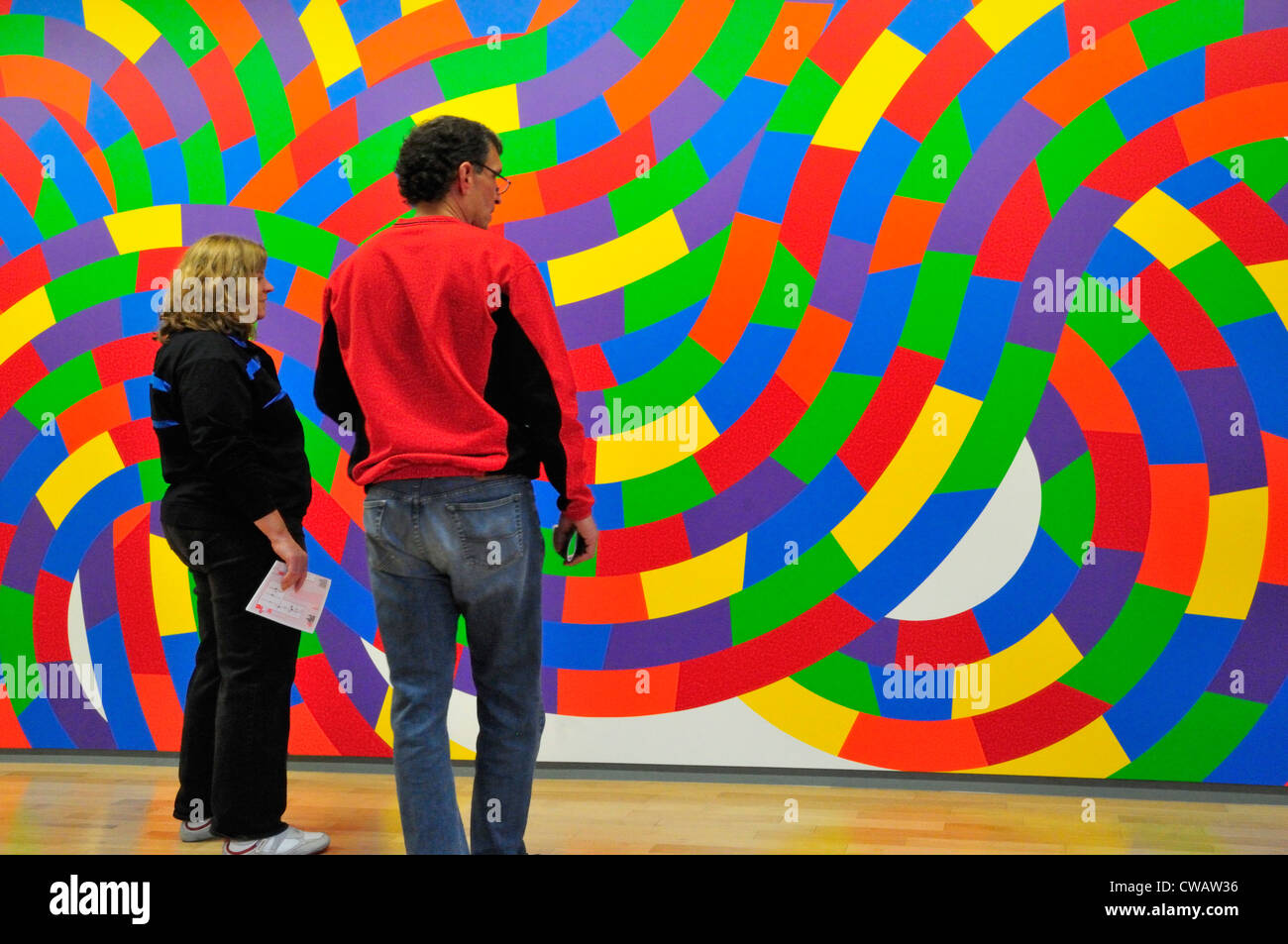 Visitors gaze at the colorful wall paintings by Sol Lewitt in his retrospective at the Massachusetts Museum of Contemporary Art Stock Photo