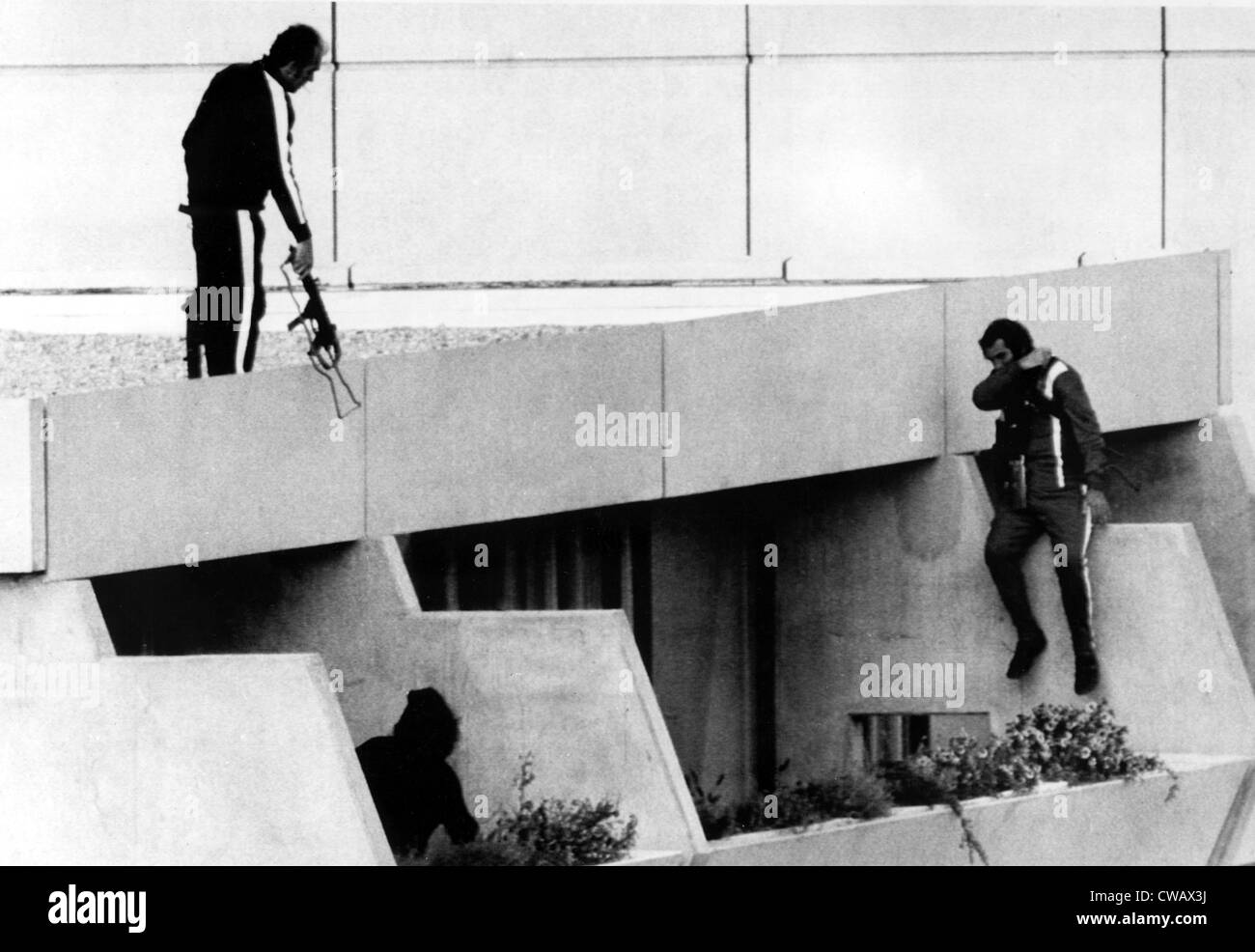 1972 Olympics, Armed Police drop into position on terrace above apartments where hostages are being held. Olympic Village, Stock Photo