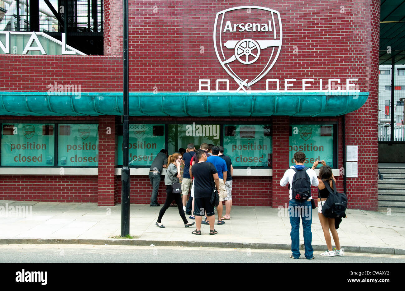 Arsenal Box Office with queue and people talking photographs, Highbury London Borough of Islington England UK Stock Photo