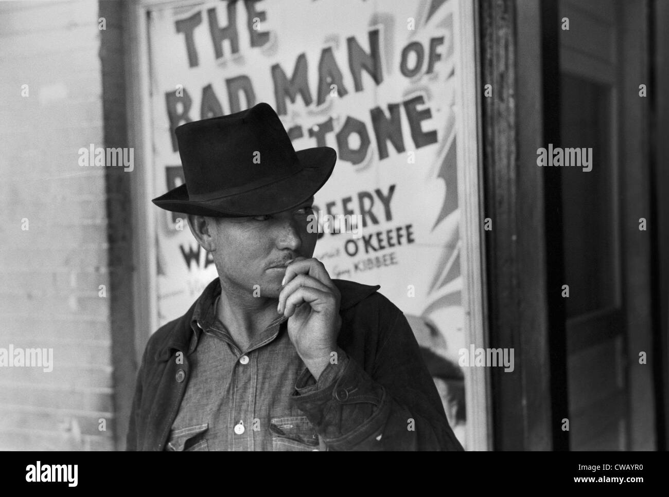 Man in front of a movie theater playing THE BAD MAN OF BRIMSTONE, Waco, Texas, photograph by Lee Russell, 1939. Stock Photo