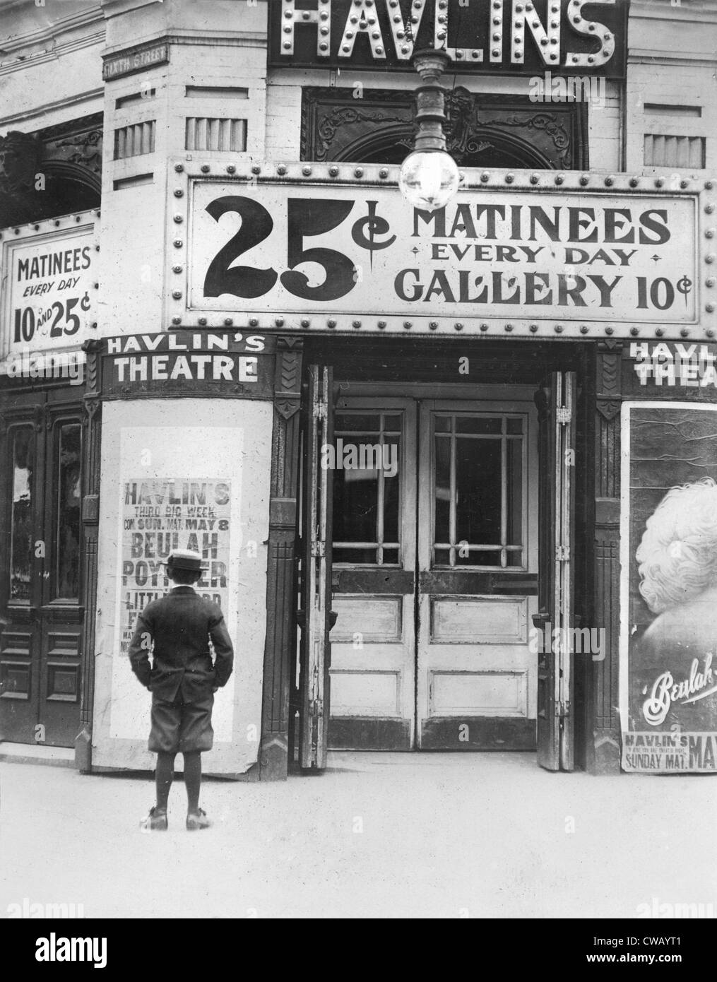 Boy in front of a movie theater showing a film with Beulah Poynter, original caption quote: 'Where the boys spend their money', Stock Photo
