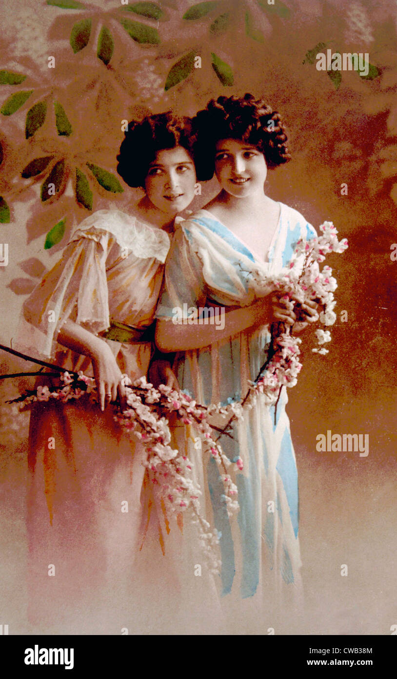 Women holding flowers, circa. 1890s. Stock Photo