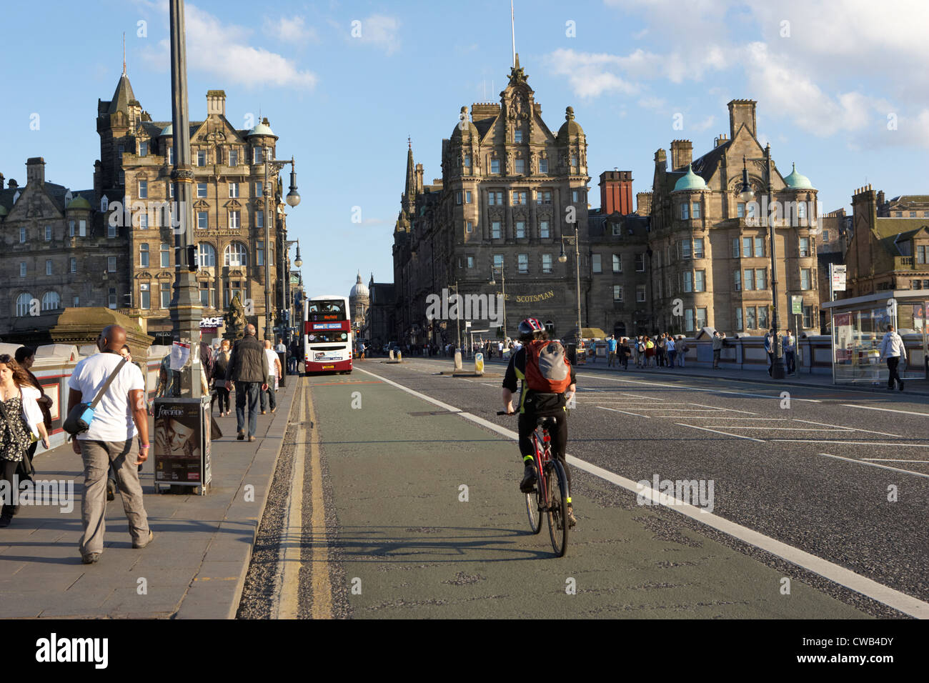 cyclist in bus lane over the north bridge in edinburgh city centre