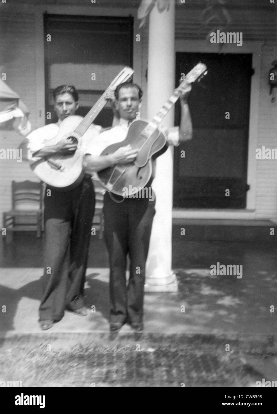 Folk Music. Lolo Mendoza and Chico Real, with guitars, at the home of Mrs. Sarah Kleberg Shelton, Kingsville, Texas. Ruby Stock Photo