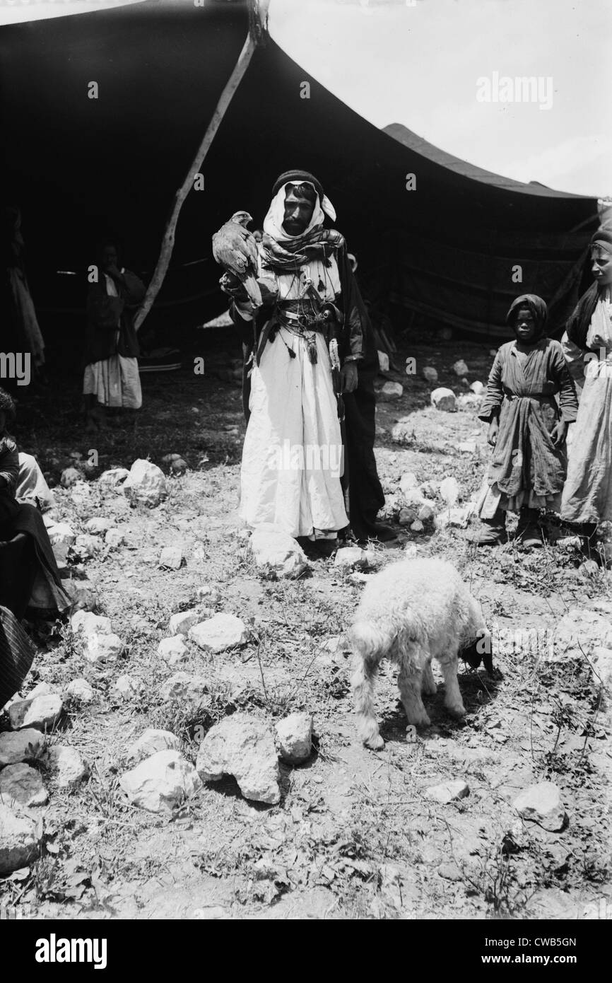 Bedouin hunter with his falcon and child, Jerusalem, photograph by American Colony Photo Department, circa 1898-1946 Stock Photo
