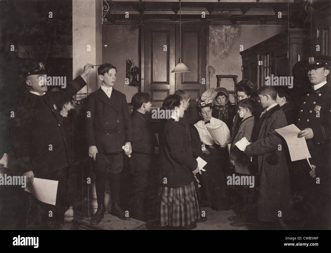 Getting working papers., New York City, photograph by Lewis Wickes Hine, February, 1908 Stock