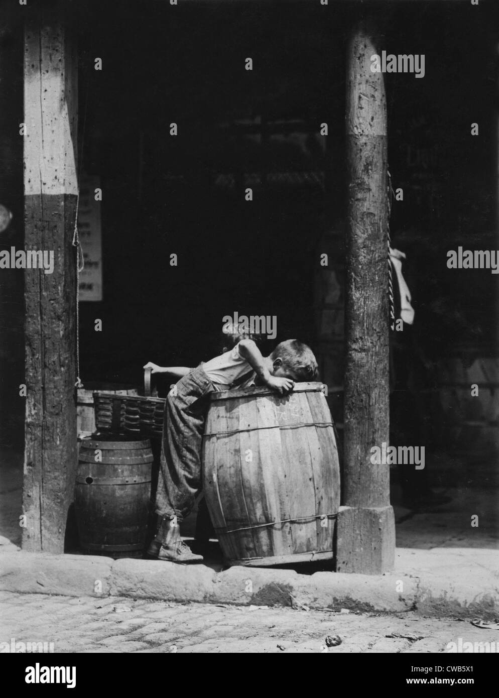 Small boys picking from barrels, from original caption: 'This boy and brother were picking discarded fruit out of barrels in Stock Photo