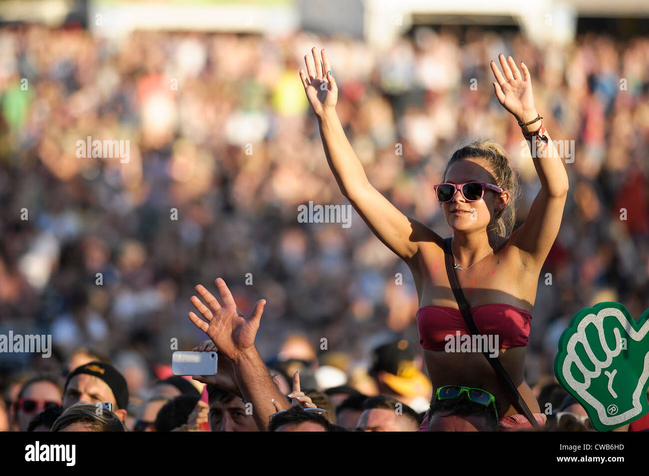A young female music fan in the crowd on shoulders at V Festival, Hylands Park 18th August 2012 Stock Photo