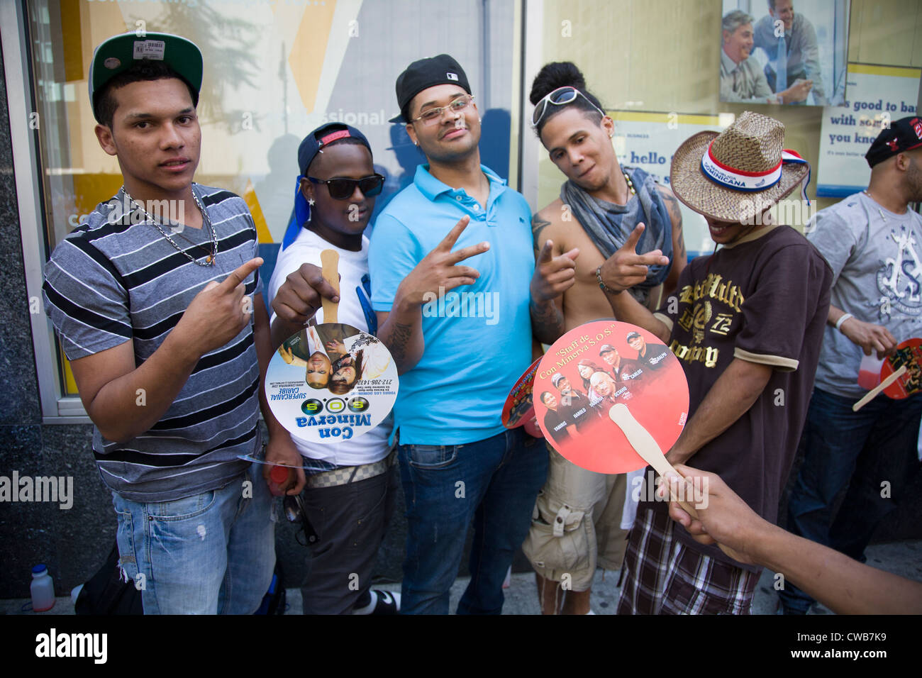 A group of energetic young men on Avenue of the Americas for the Dominican Day Parade in New York City. Stock Photo