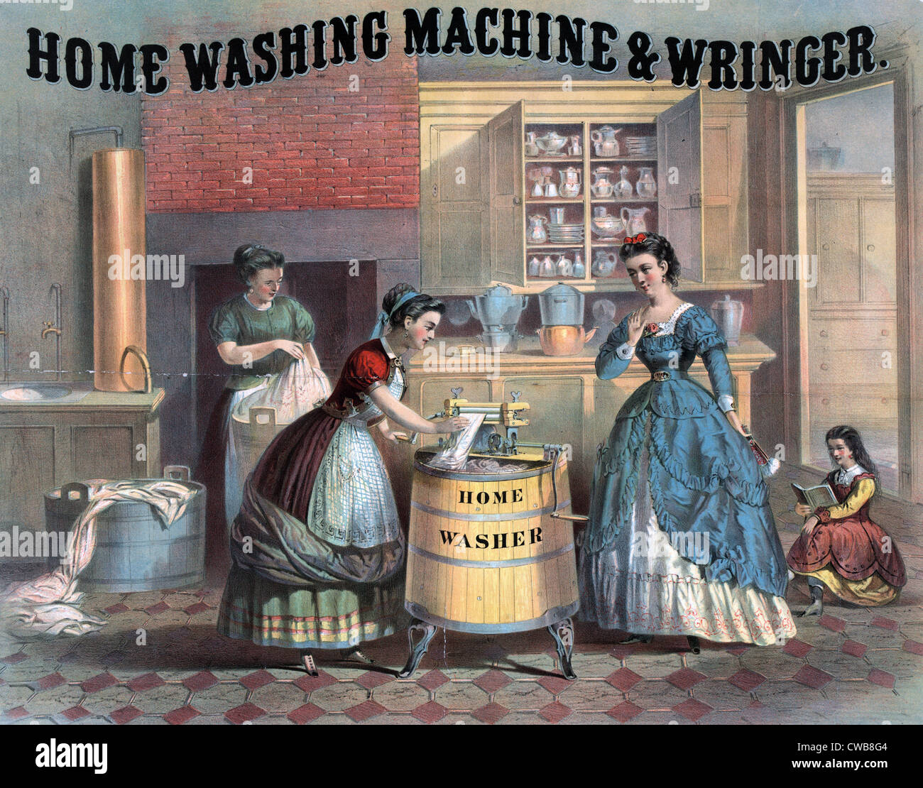 Domestic science. Interior view of a kitchen showing woman using a washing machine as her employer watches. In background Stock Photo