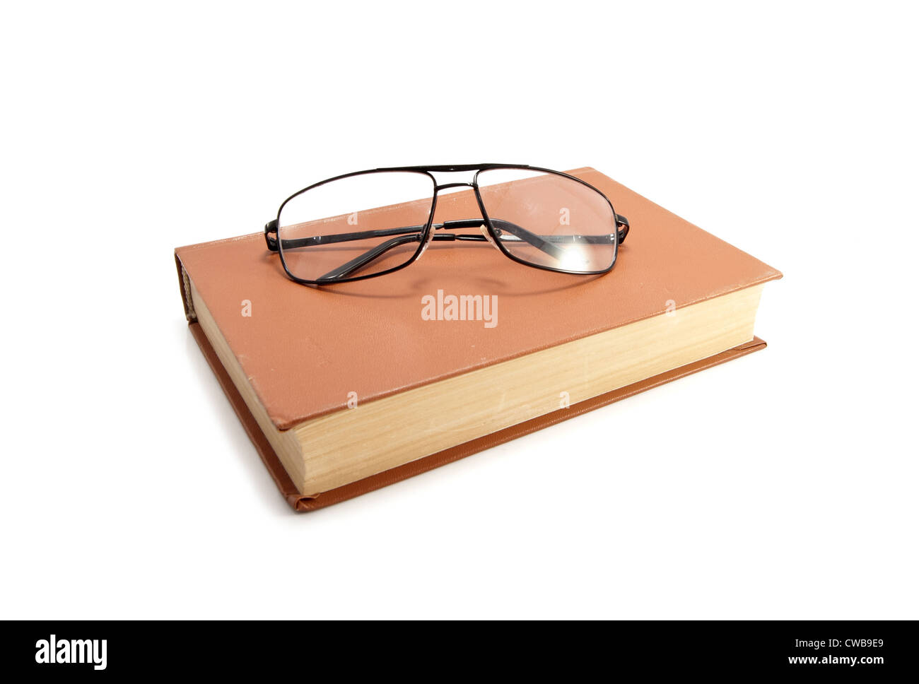 old book and glasses on a white background Stock Photo