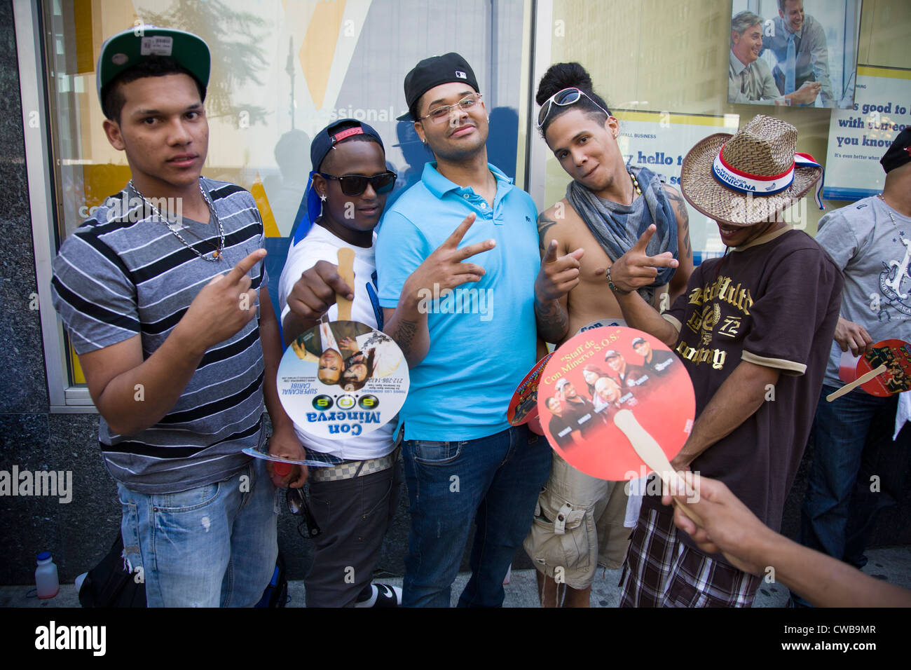 A group of energetic young men on Avenue of the Americas for the Dominican Day Parade in New York City. Stock Photo