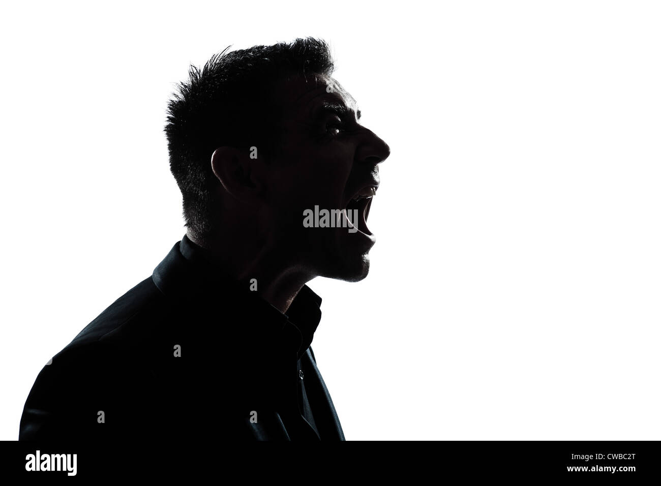 one caucasian man portrait silhouette profile screaming angry in studio isolated white background Stock Photo