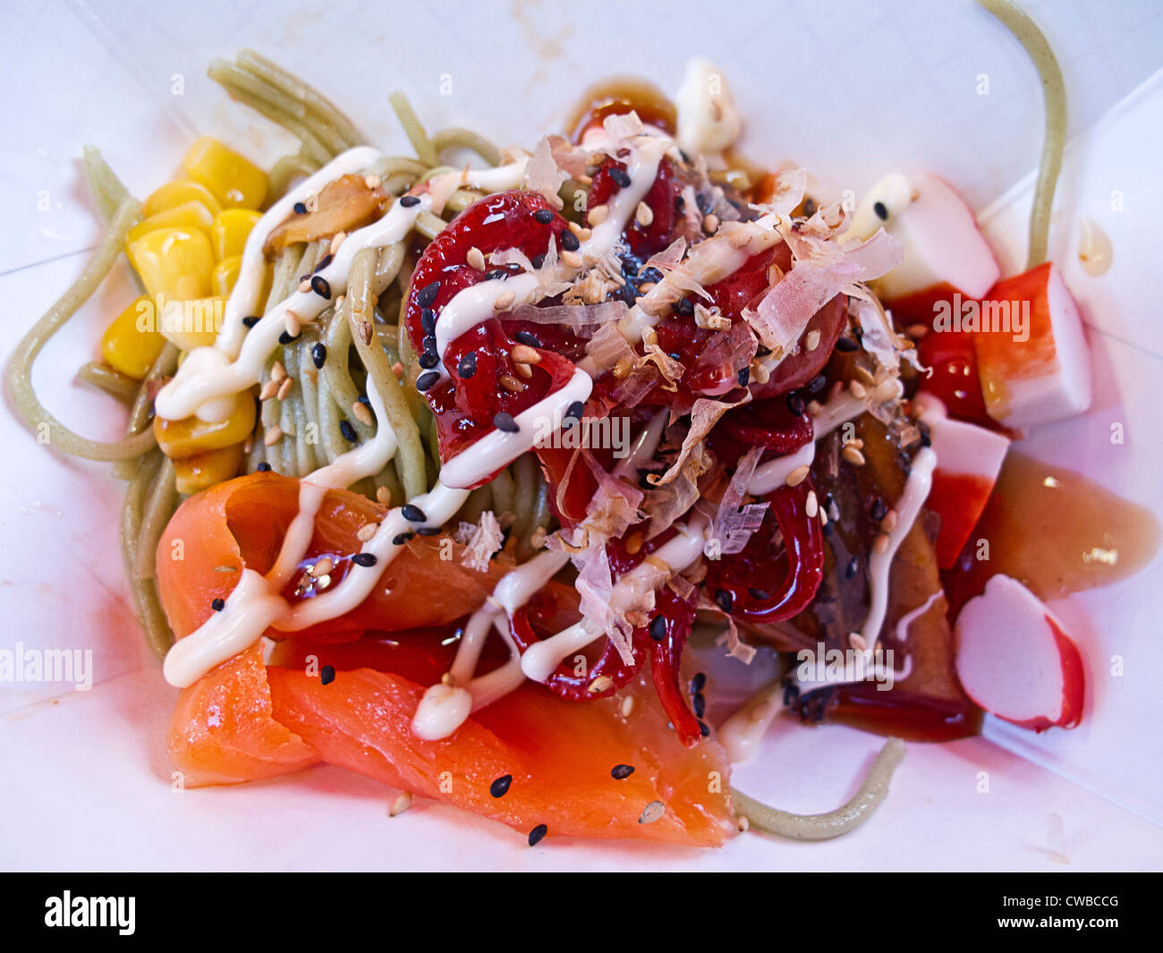 Soba Japanese buckwheat noodles topped with assorted vegetables and fish served at Richmond Night Market, Richmond, BC, Canada Stock Photo