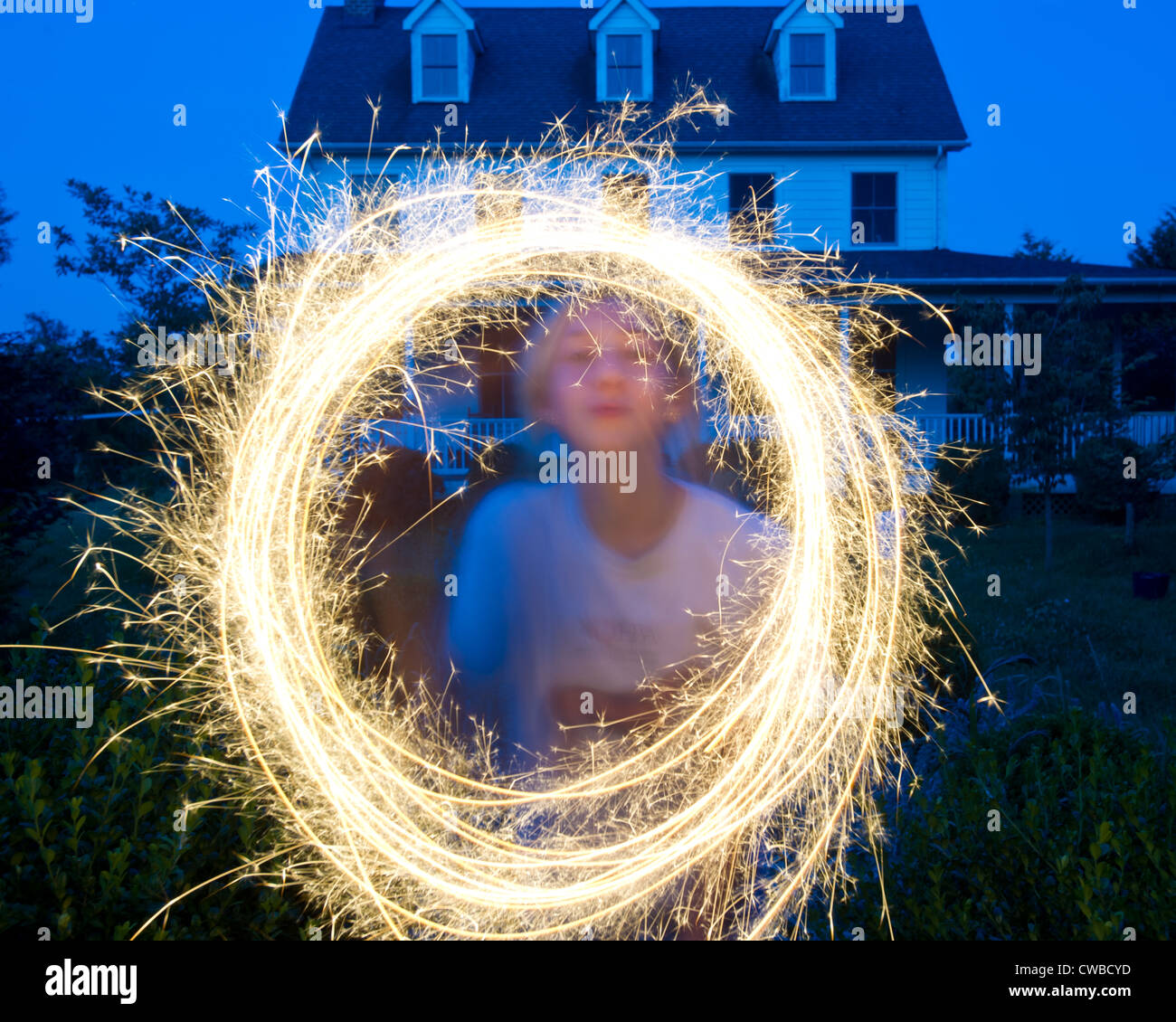 Young girl playing with sparkler on the 4th of July Stock Photo