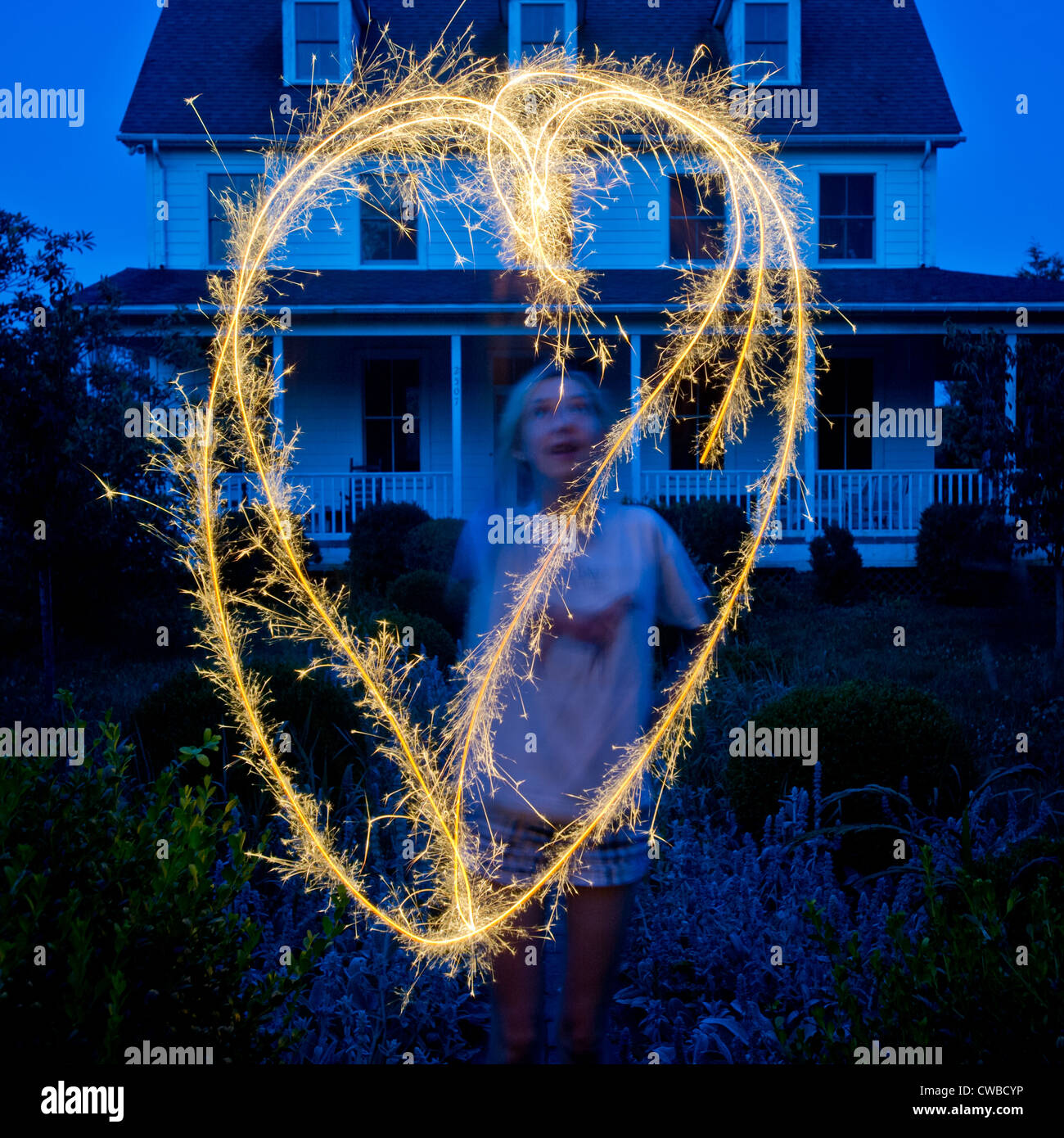 Young girl playing with sparkler on the 4th of July Stock Photo