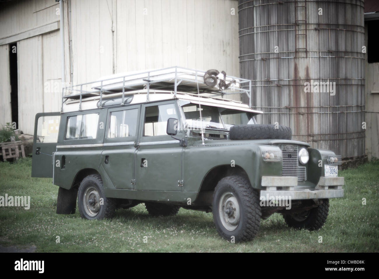 Land Rover Series II A in front of silo and barn on a farm Stock Photo
