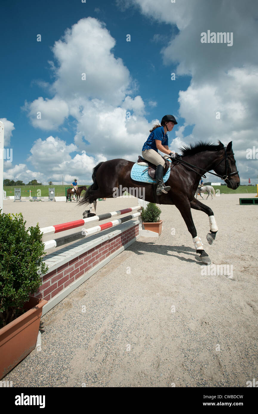 Horseback riding at equestrian stables Stock Photo