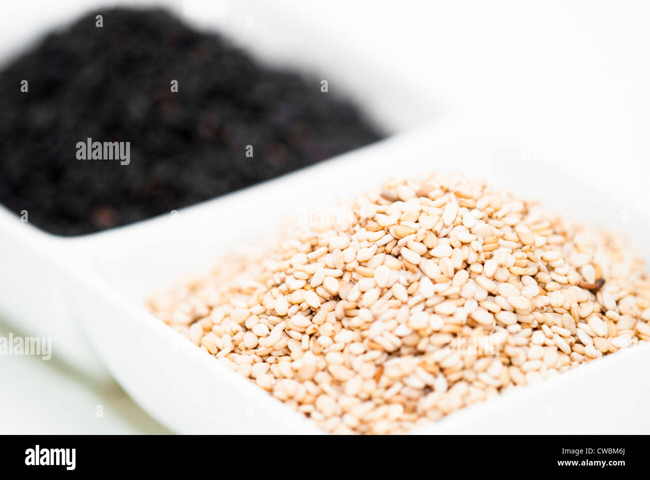 black and white sesame seed in white bowl Stock Photo Alamy